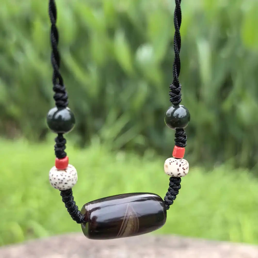 Adjustable hand-woven black cord on Silk Agate Phoenix Eye necklace