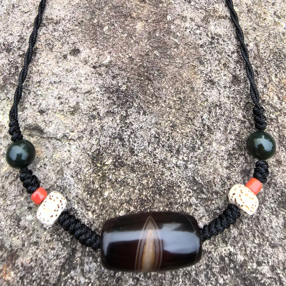 Close-up of naturally formed Phoenix Eye pattern on Silk Agate Dzi bead