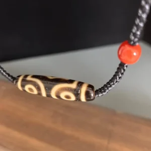 Natural red agate accent beads on three-eye Tibetan Dzi bead choker necklace, organic stone texture