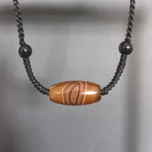 Vajra Eye Silk Agate pendant necklace with natural black agate beads and handwoven black cord closeup