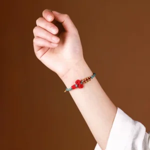 Wenchang Knot Bracelet - red and mist blue handwoven cord worn on wrist