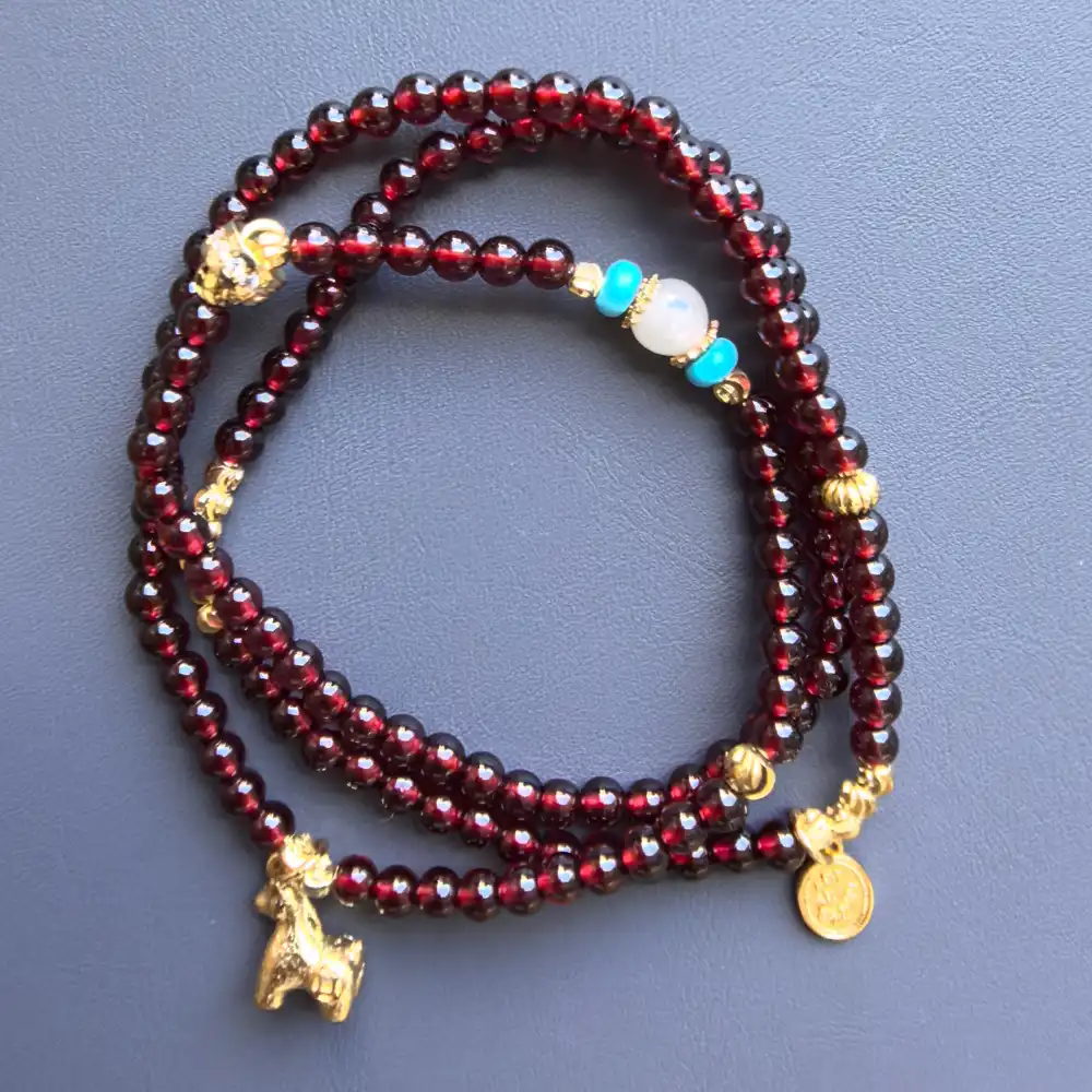Coiled view of the garnet 3-wrap bracelet showing triple wrap | Glint & Grain
