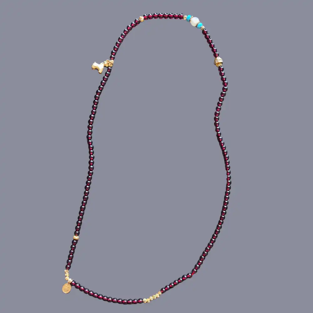 Full strand of the garnet 3-wrap display bracelet on neutral background | Glint & Grain