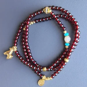 Top view of garnet 3-wrap bracelet with turquoise and crystal accents | Glint & Grain