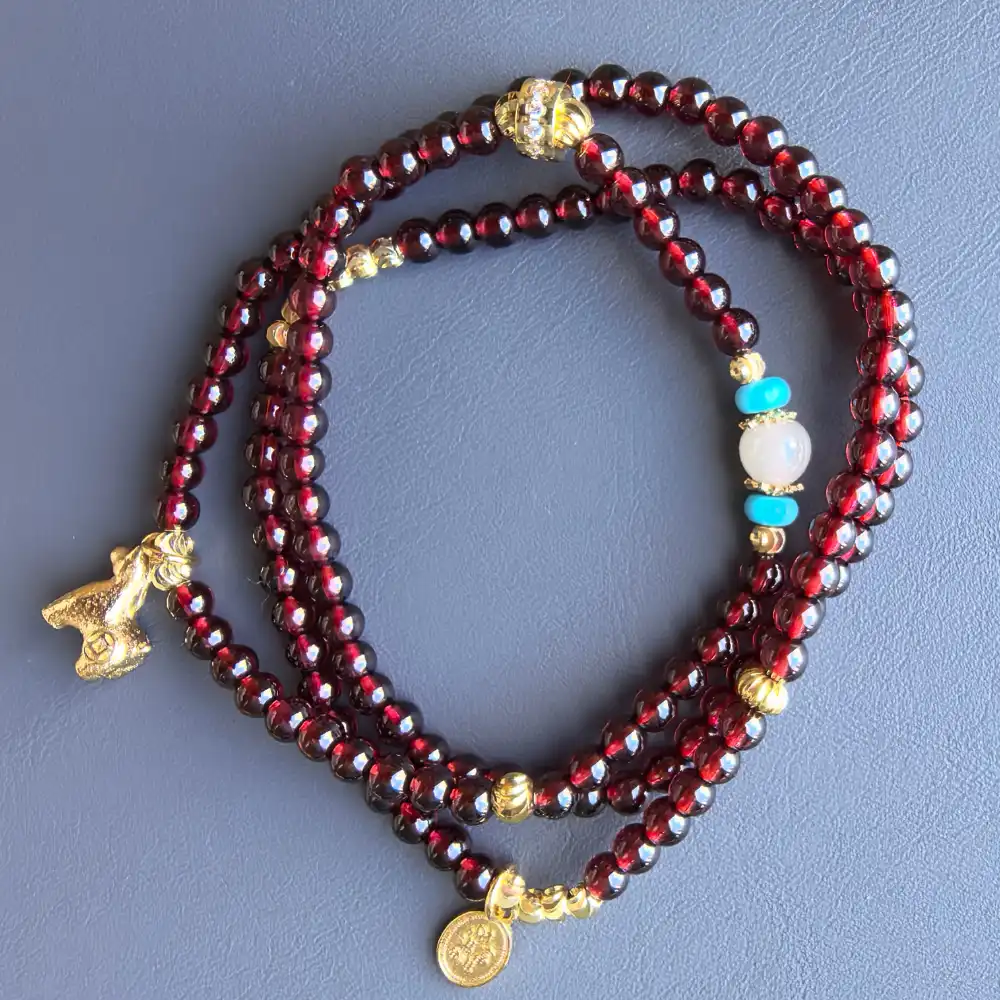 Top view of garnet 3-wrap bracelet with turquoise and crystal accents | Glint & Grain