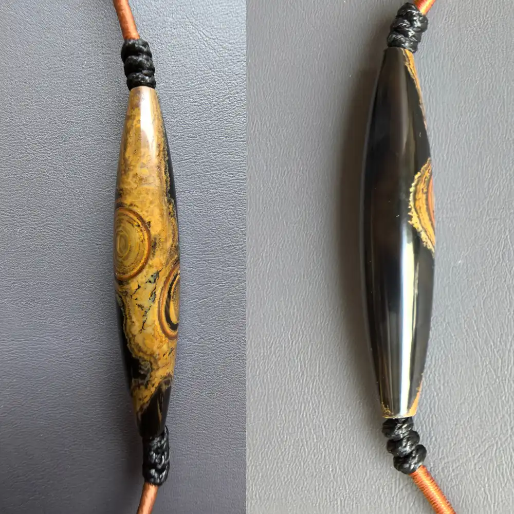 Diagonal view of the two-eye eye-stone lance pendant | Glint & Grain
