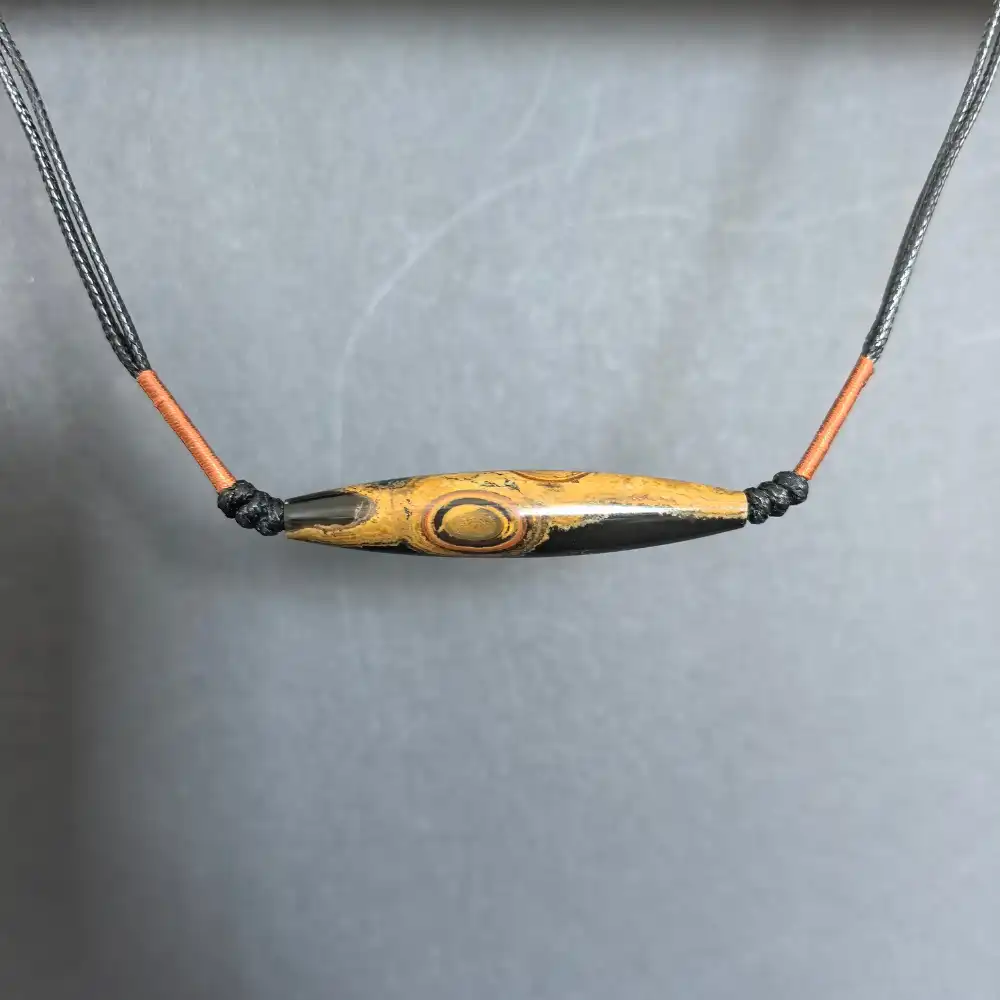 Close-up of the concentric geological eye on the two-eye eye-stone lance pendant | Glint & Grain