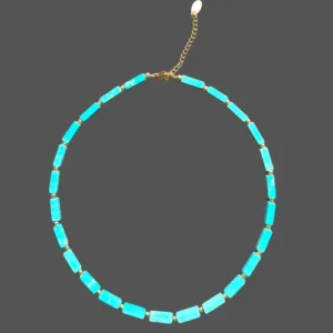 Magnesite turquoise necklace arranged in a circle, showing the full strand with its gold-tone spacer beads.