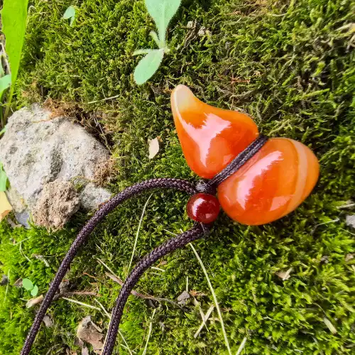 Natural agate gourd pendant on a dark braided cord resting on green moss | Glint & Grain